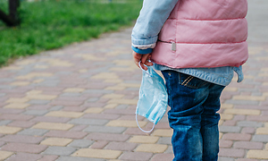 Child Holding Mask